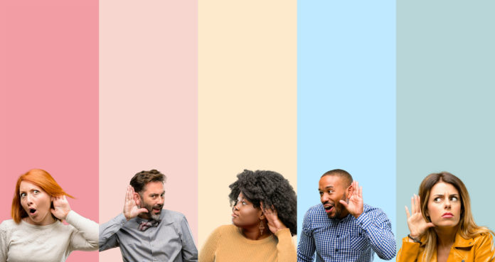 Cool group of people, woman and man holding hand near ear trying